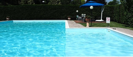 Seasonal outdoor pool, pool umbrellas, pool loungers