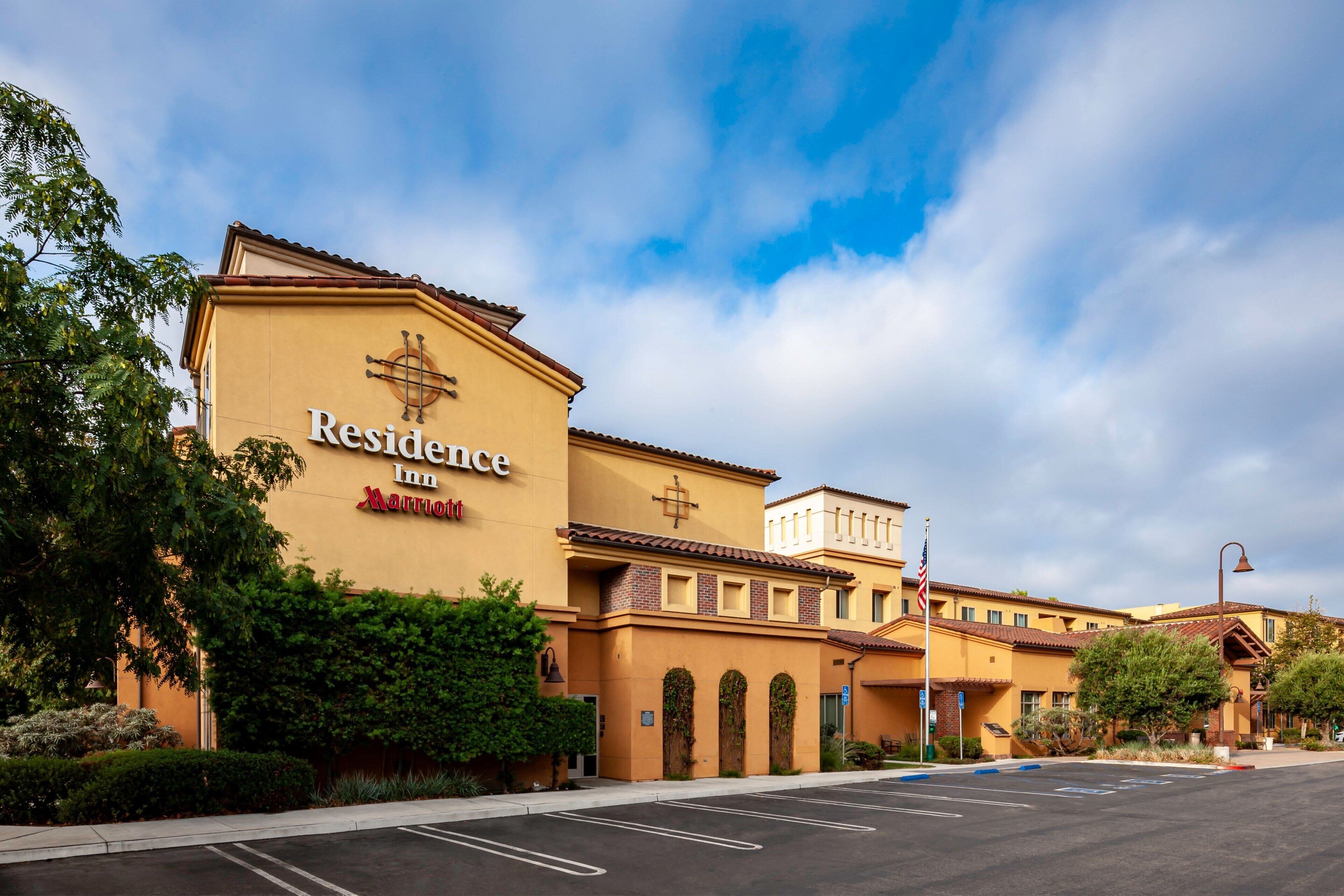 A hotel with a yellow facade, a cross symbol, and the name "Residence Inn Marriott" visible.