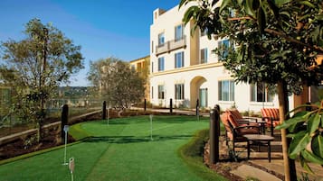 Enjoy golfing and relaxation in a serene natural setting with outdoor seating and comfortable spaces.