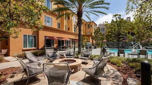 A patio area with outdoor seating, a fire pit, and a pool.