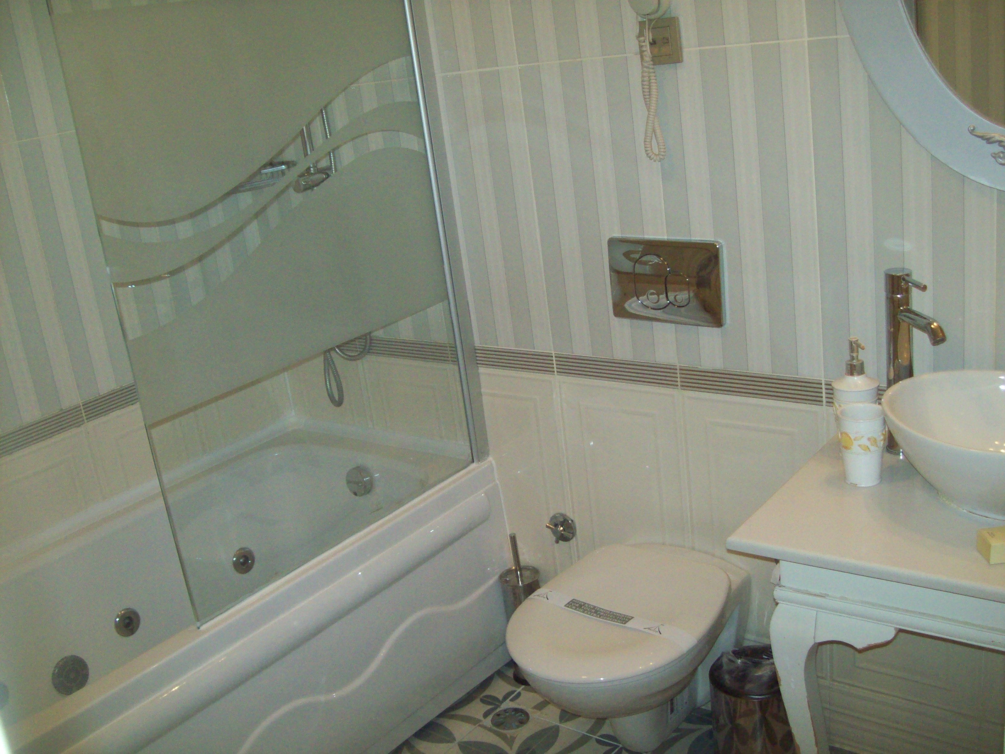 A bathroom with a bathtub, toilet, and sink.