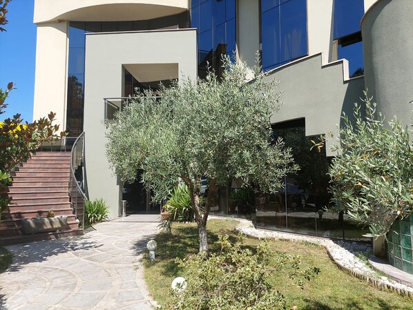 A modern building with a stone pathway leading to a staircase. - Hotel Green (Vaqarr)