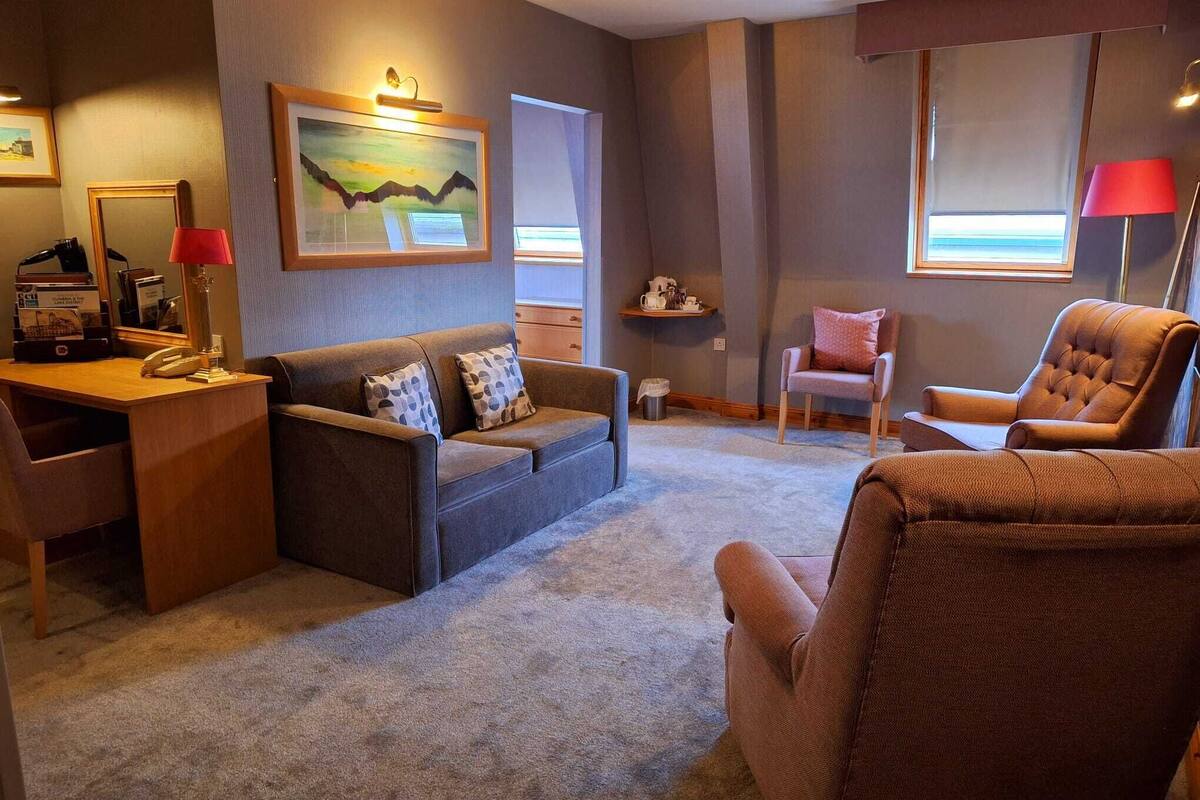 deluxe suite (washington central hotel) | living area | 32-inch led tv with digital channels, tv