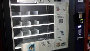 A self-service kiosk with multiple service options, including product code composition and payment.