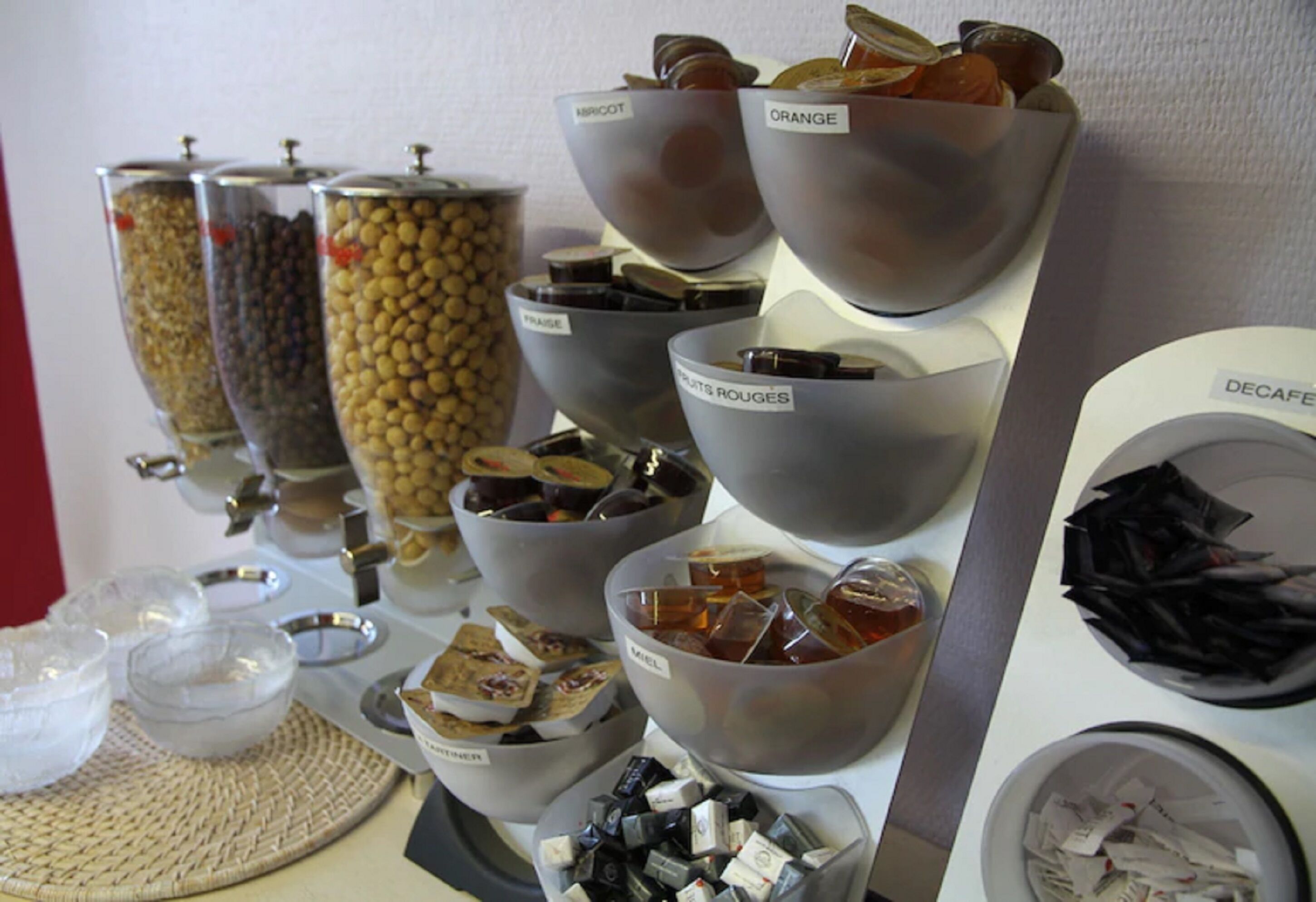 A beverage station with labeled dispensers for different types of drinks.
