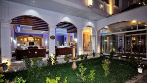 A hotel lobby with a reception desk, seating area, and a fountain. - Grand Atakum Hotel (Atakum)
