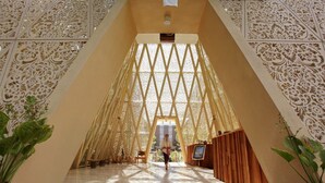 A spacious atrium with a high ceiling and intricate wall designs. - Ananta Legian Hotel (Legian)
