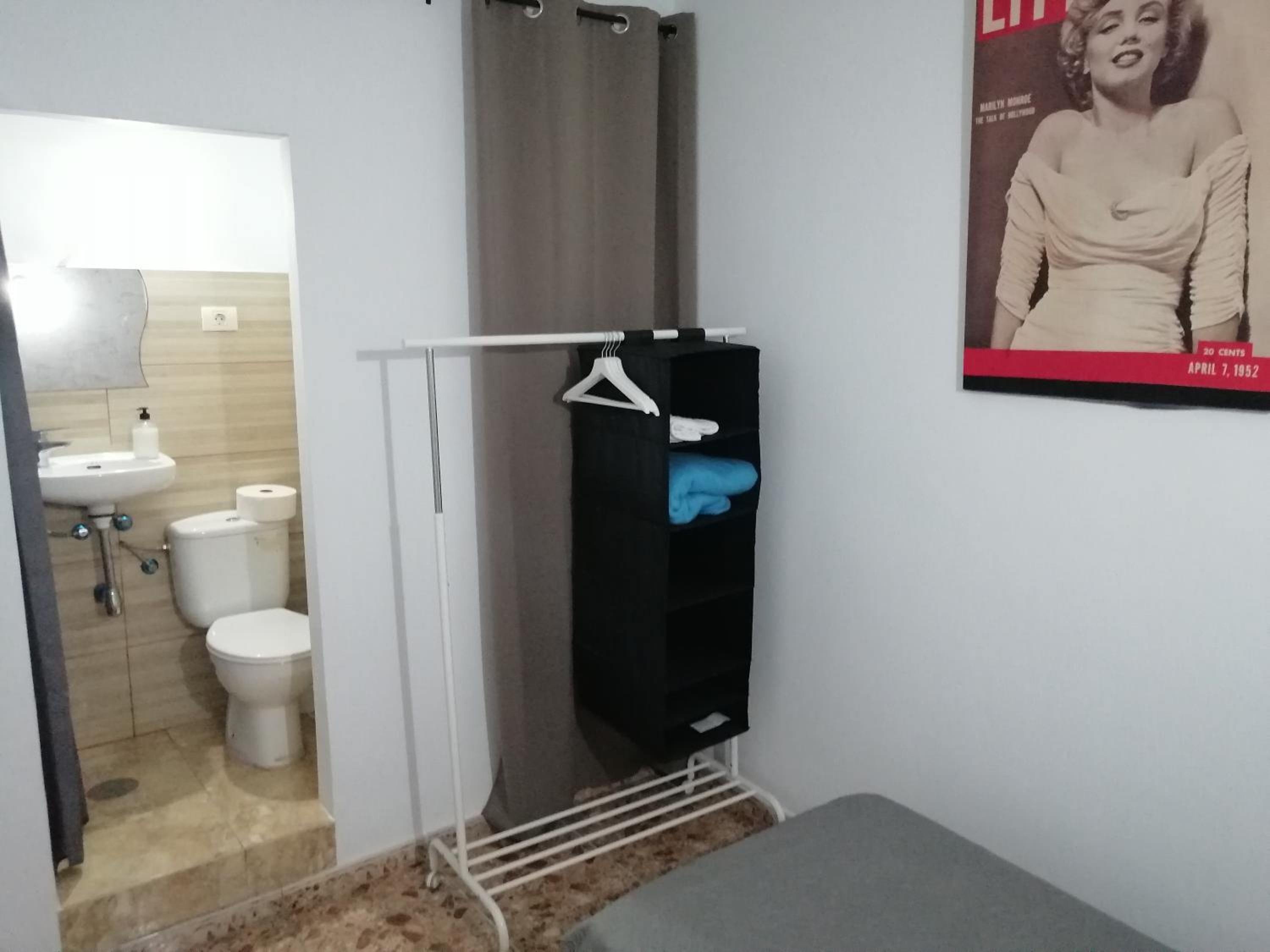 A bathroom with a sink, toilet, and shower curtain.