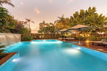 Outdoor pool, pool umbrellas, sun loungers. The Billi Resort
