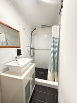 Shower, rainfall showerhead, hair dryer, towels