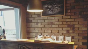A restaurant counter with a wooden backdrop and a sign reading "Aussie Steak House Licensed Restaurant."