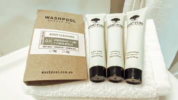 A set of body wash, shampoo, and conditioner tubes with a label for a body cleanser.
