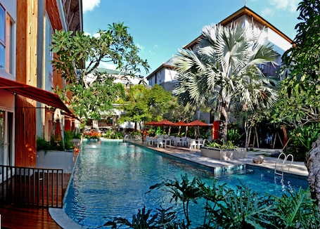 Outdoor pool, open 7:00 AM to 7:00 PM, pool umbrellas, pool loungers. HARRIS Hotel & Residence Sunset Road Bali