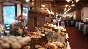 A buffet with various baked goods and pastries.