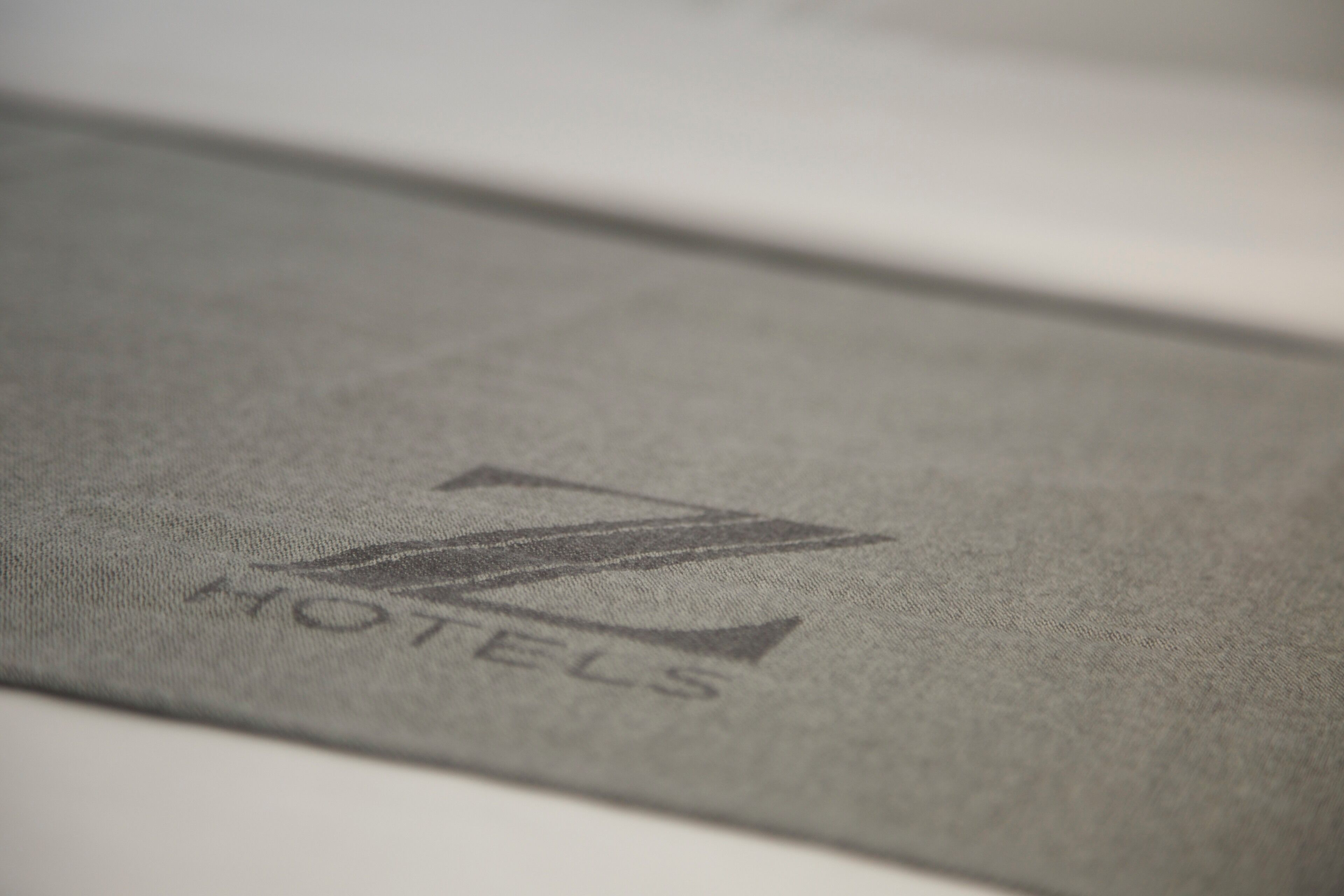 A close-up of a fabric with a logo and the word "HOTELS" visible.