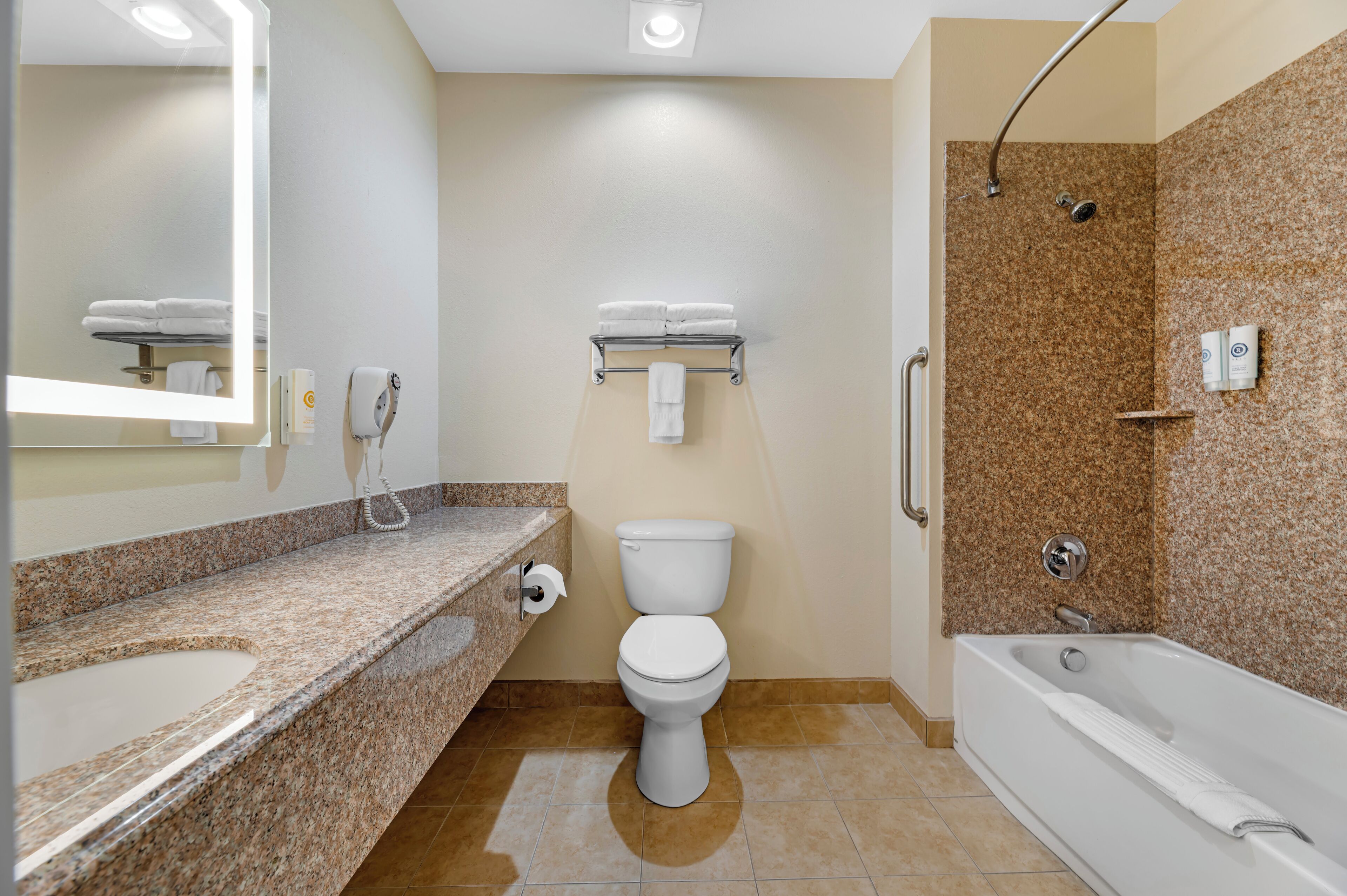 A bathroom with a sink, toilet, and bathtub.