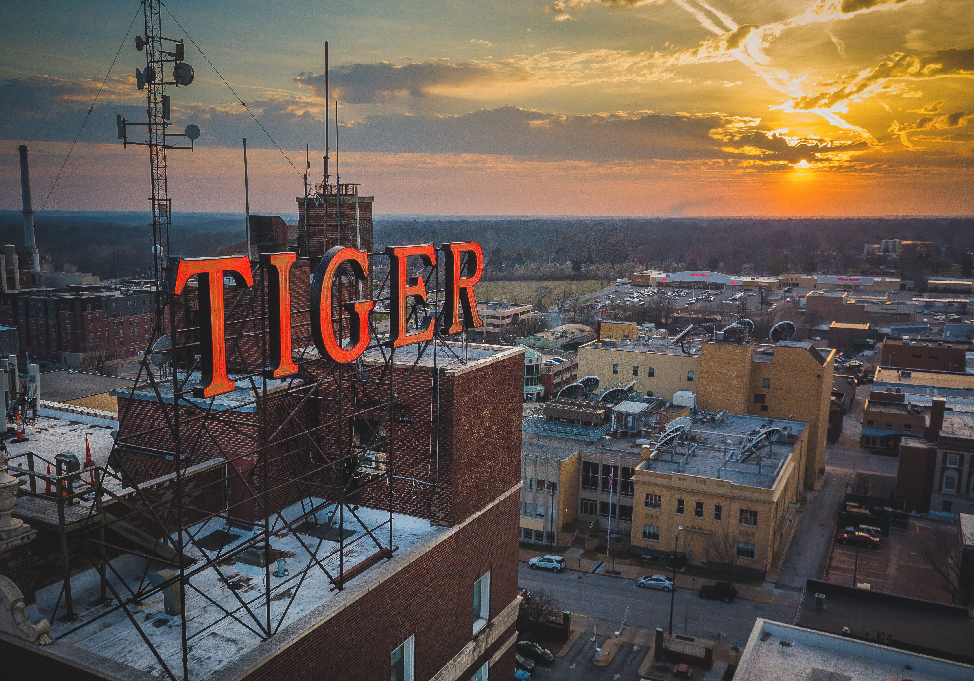 A cityscape with a prominent building featuring the word 'TIGER' in large letters.