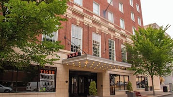 A brick building with a marquee sign reading "TIGER" and a theater entrance.