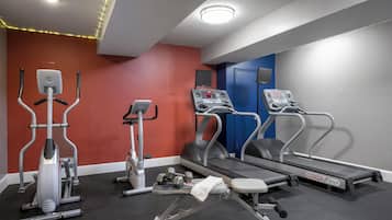 A gym with treadmills, an elliptical, and free weights.