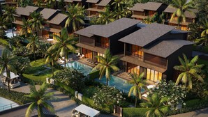 Un resort moderno con varias edificaciones, una piscina central y exuberante vegetación tropical.