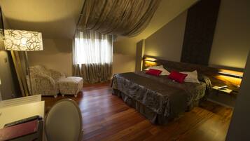 A bedroom with a bed, a desk, a chair, and a window with curtains.