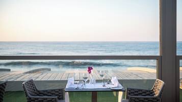 A table set for two with a view of the ocean.