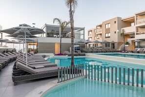 Outdoor pool, open 8:00 AM to 8:00 PM, pool umbrellas, pool loungers