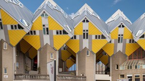 A row of modern buildings with unique angular roofs and yellow accents. - Stayokay Rotterdam - Hostel to Stayokay Rotterdam - fully renovated April 2026 (Rotterdam)