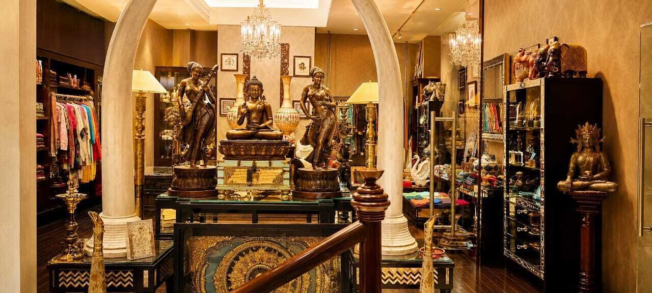 A luxurious interior with ornate statues, chandeliers, and a variety of decorative items.
