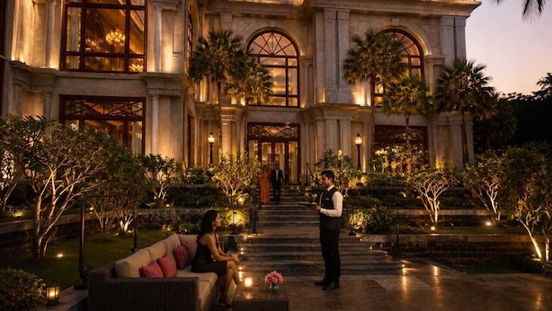 A grand building with arched windows and a well-lit entrance.