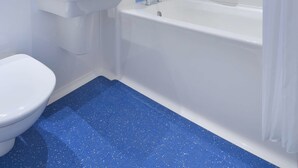 A modern bathroom with a white sink, toilet, and bathtub. - Travelodge Maidstone Central (Maidstone)