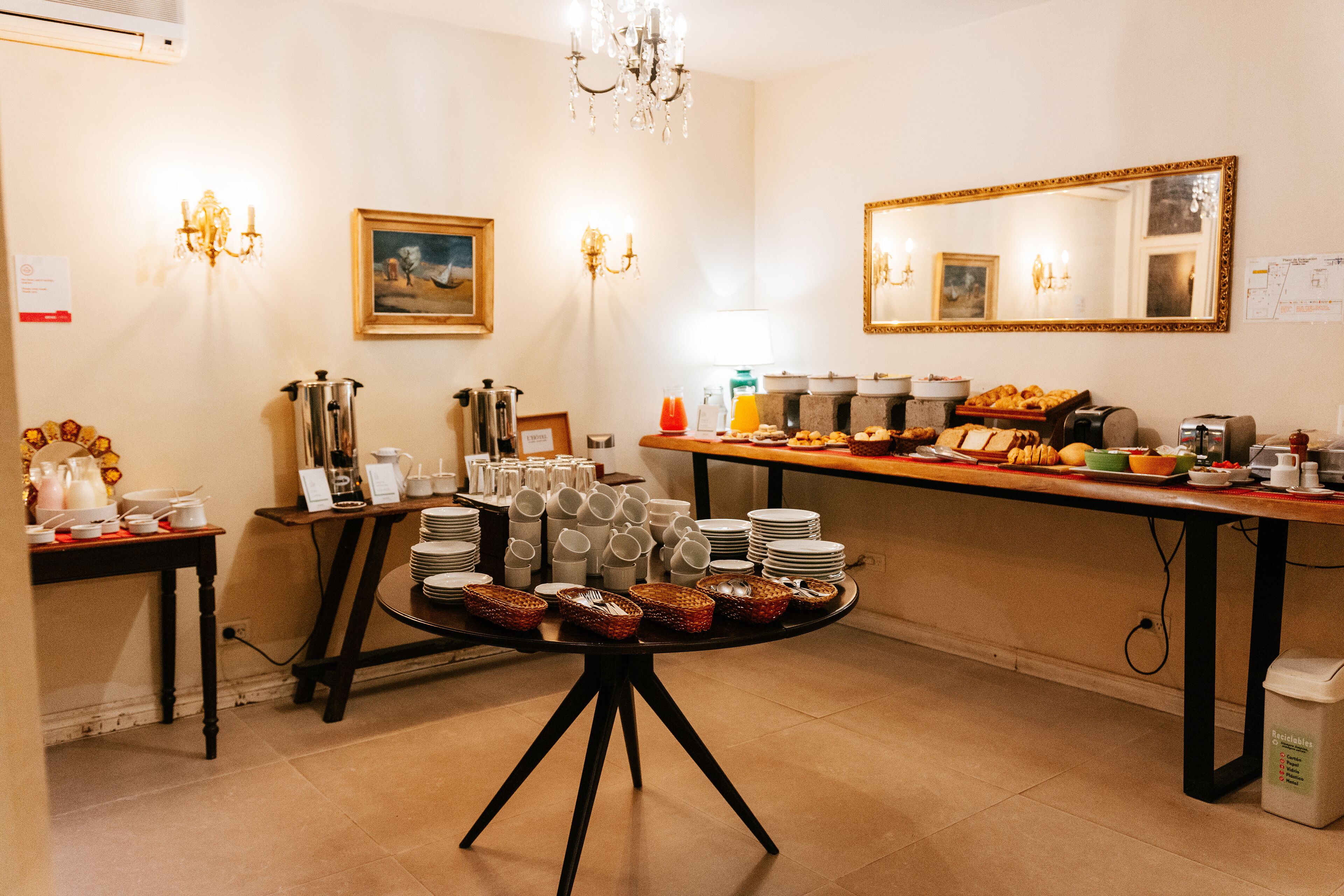 A buffet setup with various food items, plates, and serving utensils.