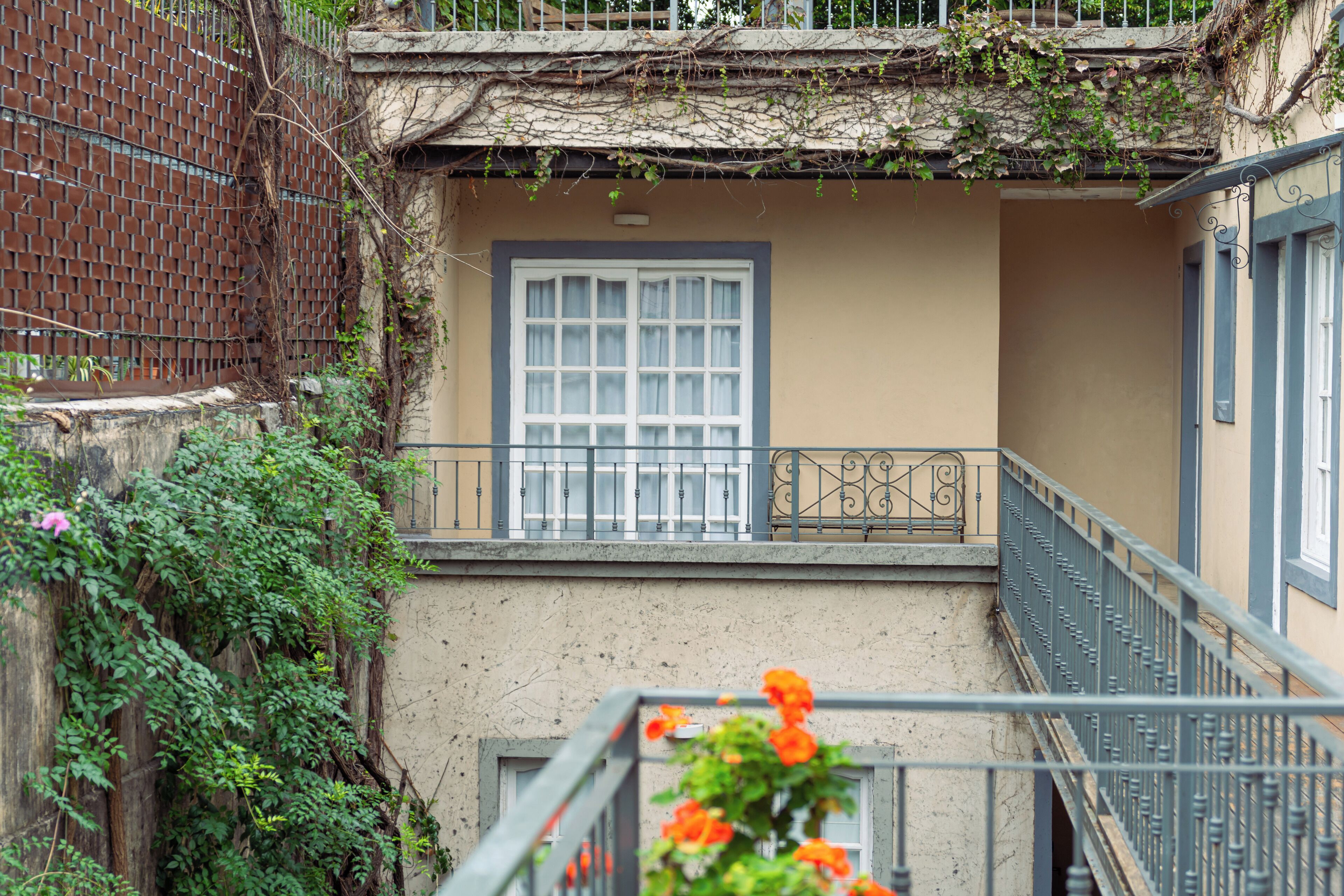 Un bâtiment doté d’un balcon, d’une fenêtre et d’une balustrade.