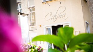A building with a sign reading "Calma" and a visible entrance. - CALMA Berlin Mitte (Berlin)