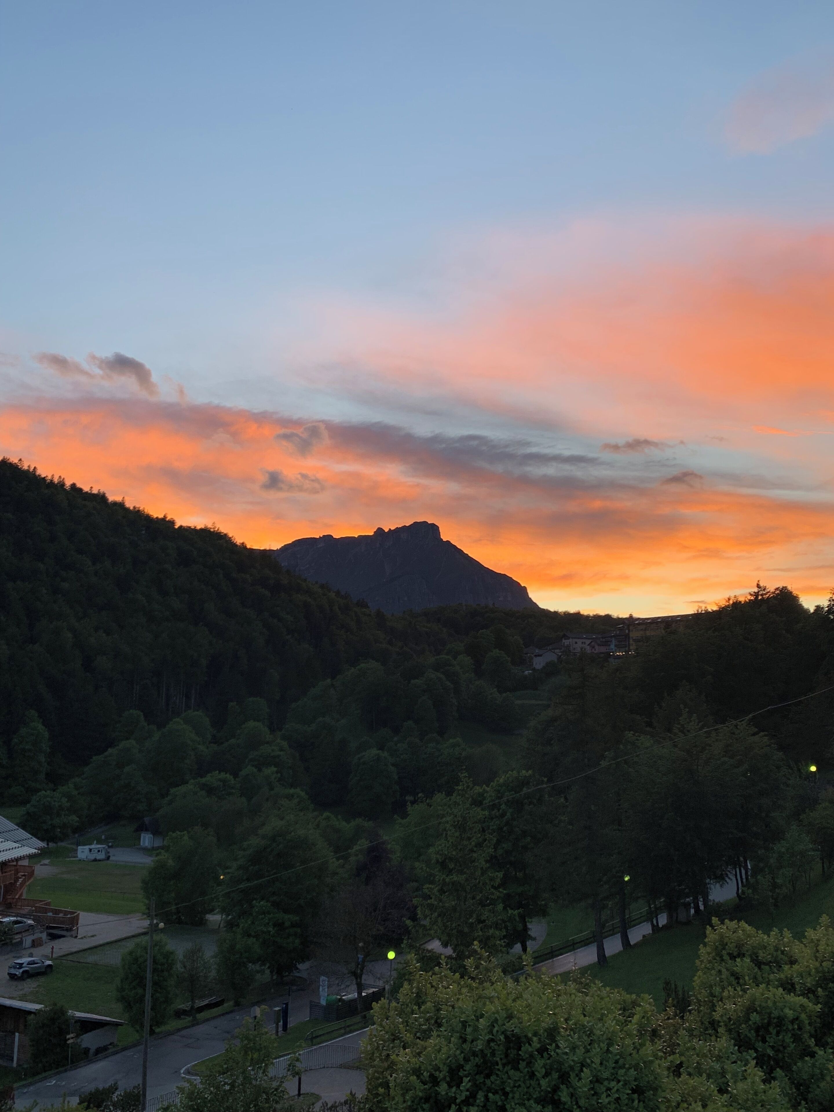A mountainous landscape with a sunset.