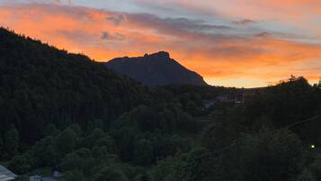 A mountainous landscape with a sunset.