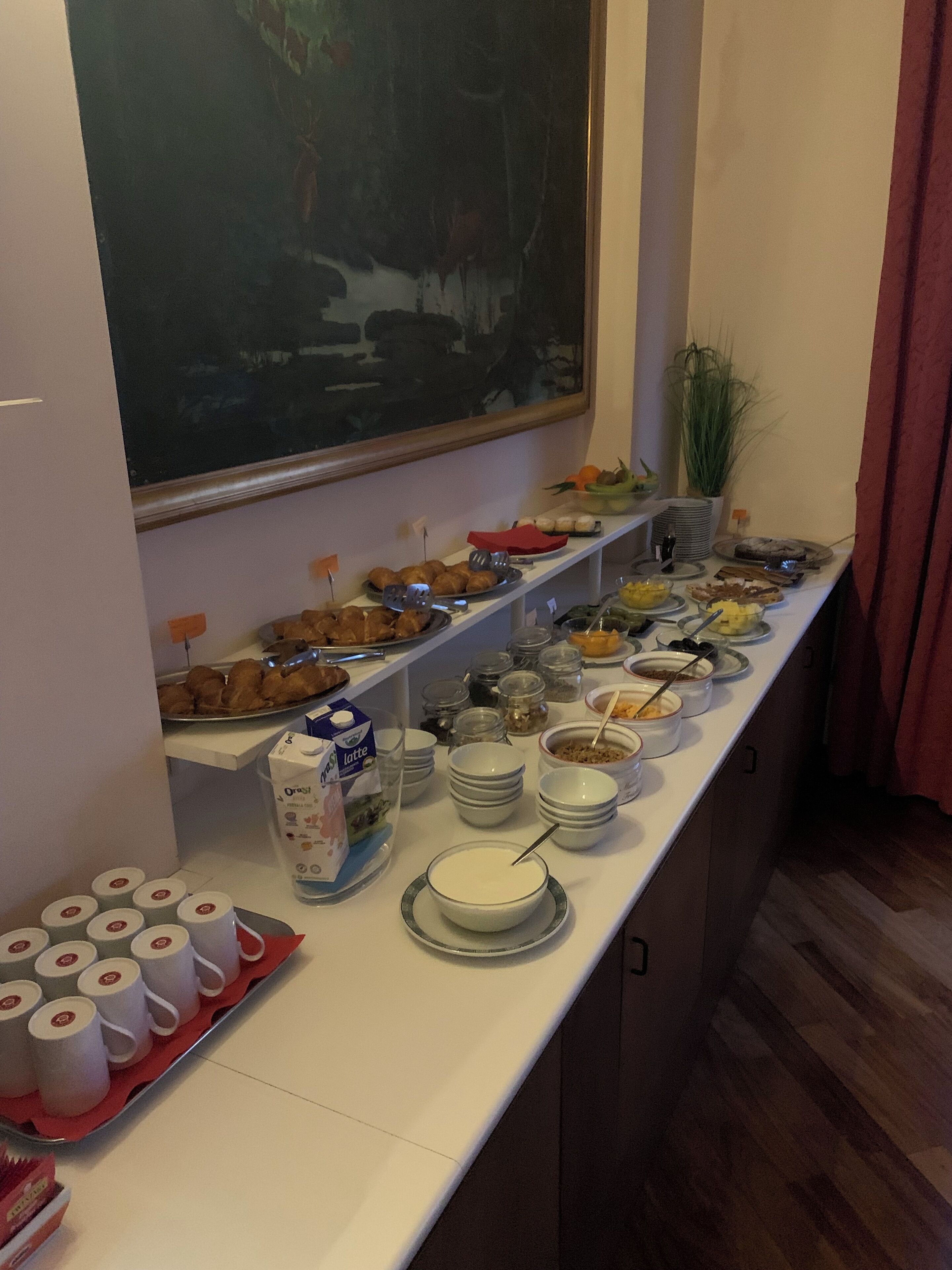A buffet setup with various food items and condiments.