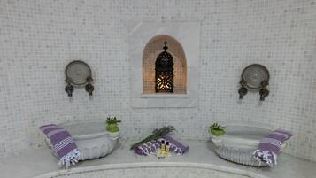 Un baño con dos lavamanos, una ventana y un detalle decorativo en la pared.
