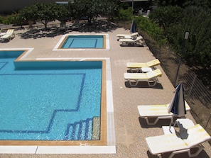 Une piscine avec plusieurs couloirs de nage et des chaises longues disposées tout autour.