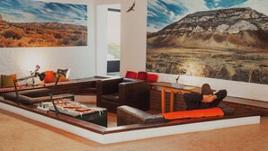 Un salon moderne avec un canapé, une table basse et un bureau avec une lampe.
