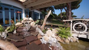A landscaped garden with a water feature, rocks, and plants. - Hôtel Sant'Andrea, The Originals Relais (Relais du Silence) (Marciana)