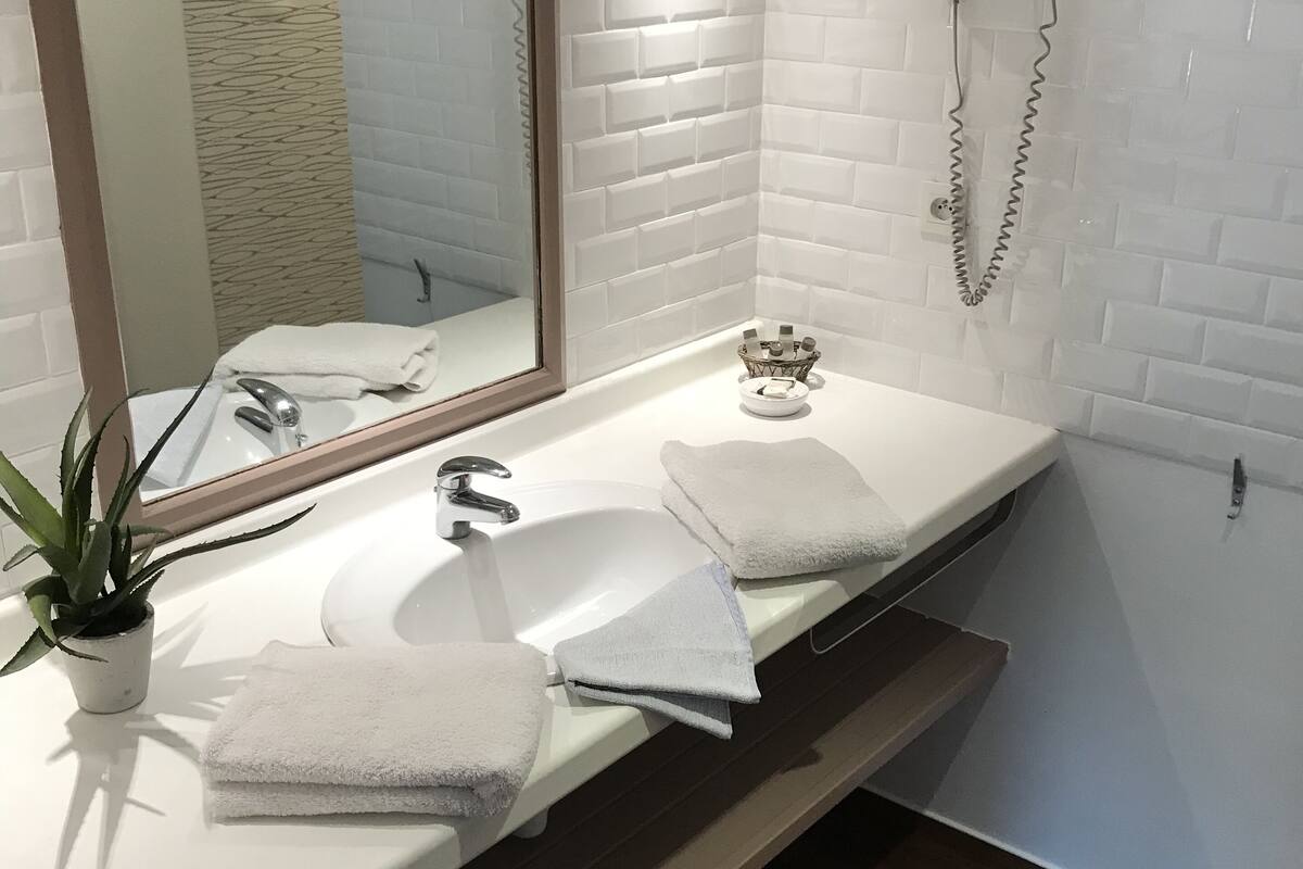 shower, eco-friendly toiletries, hair dryer, towels