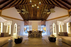 A spacious lobby with a high ceiling, two chandeliers, and a central seating area with a table and chairs. - Dusit Thani Maldives - 50 percent off on Transfers for Stays of 5 Nights stay until 20 December 2026 (Mudhdhoo)