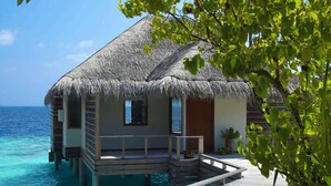 An overwater bungalow with a thatched roof, wooden deck, and a small pool. - Dusit Thani Maldives - 50 percent off on Transfers for Stays of 5 Nights stay until 20 December 2026 (Mudhdhoo)