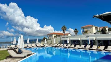 Seasonal outdoor pool, open 7 AM to 8:30 PM, pool umbrellas