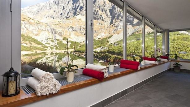 A modern room with large windows offering a mountain view.