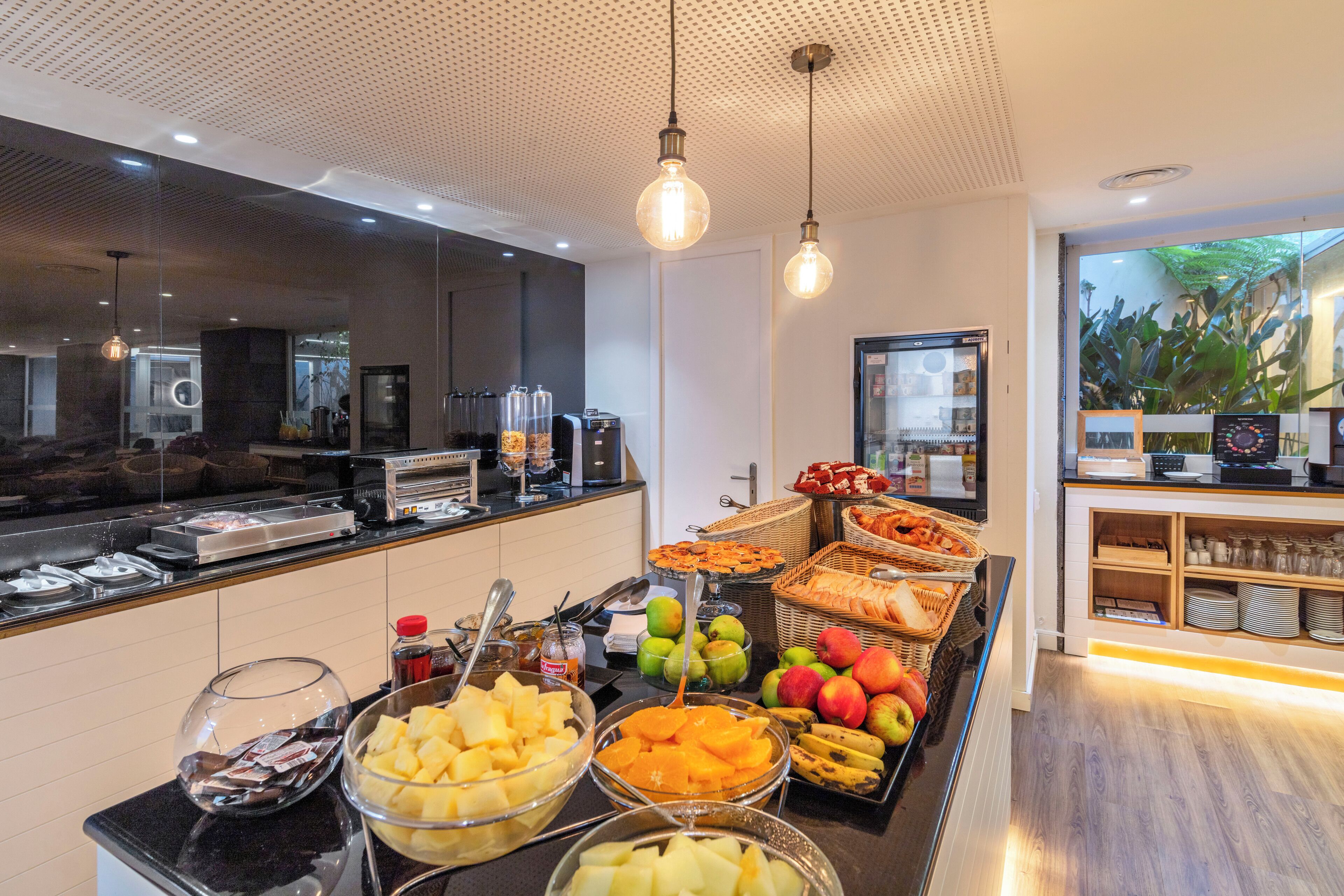 A buffet area with various fruits and breakfast items.