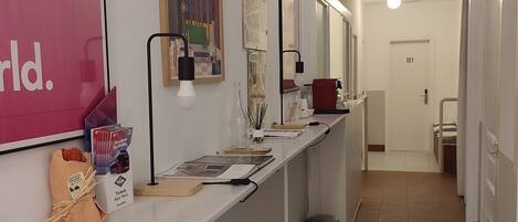A hallway with a reception desk, a trash bin, and a door labeled 101.