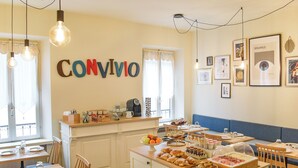 A breakfast buffet setup with various food items and a coffee machine. - Hotel Broletto Mantova - centro storico (Mantua)