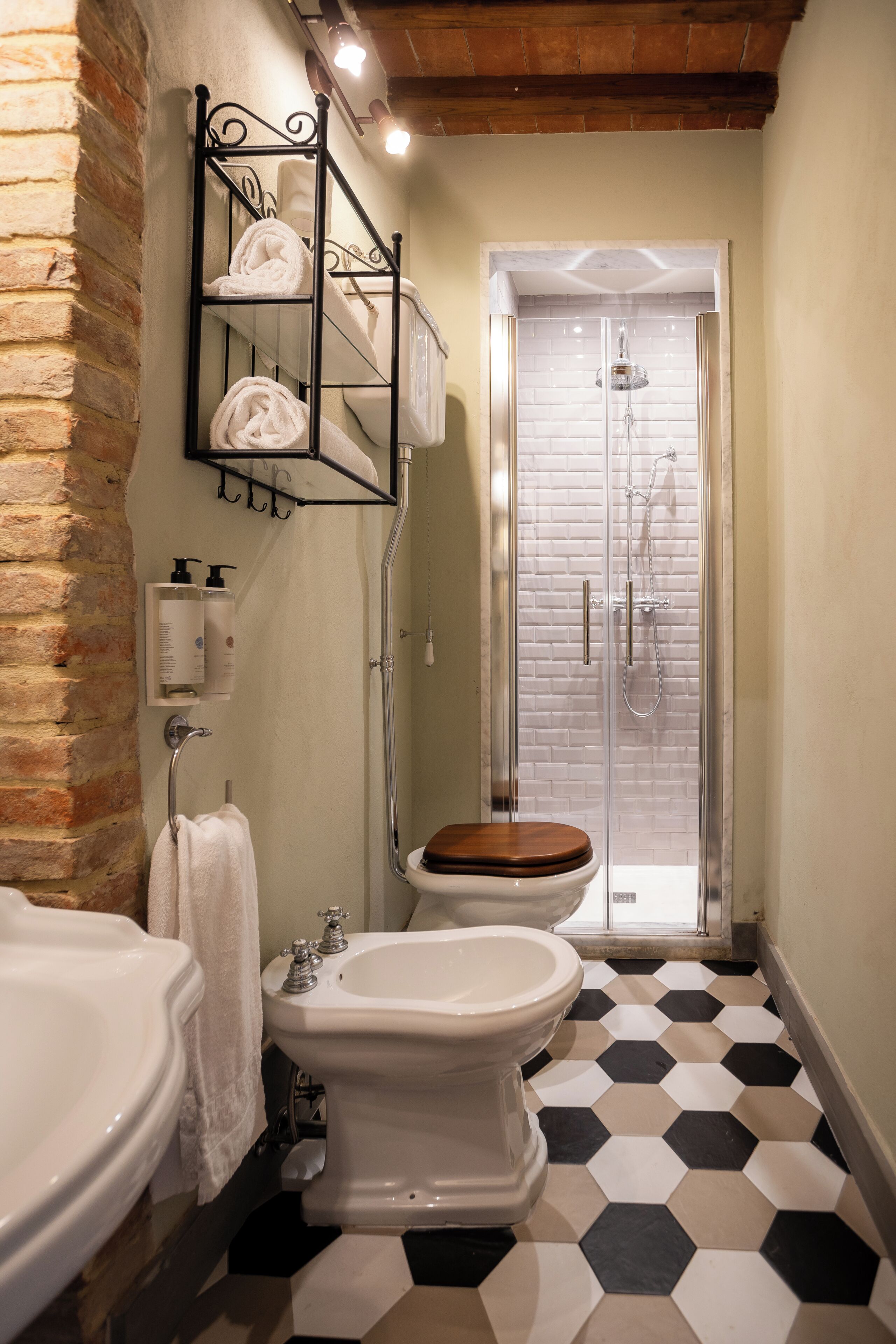 A bathroom with a shower, a toilet, and a bidet.